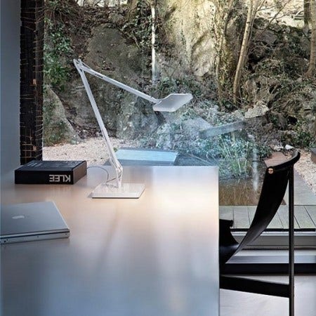 The Flos Kelvin LED Table Lamp provides direct lighting, with a pantograph arm and adjustable head.