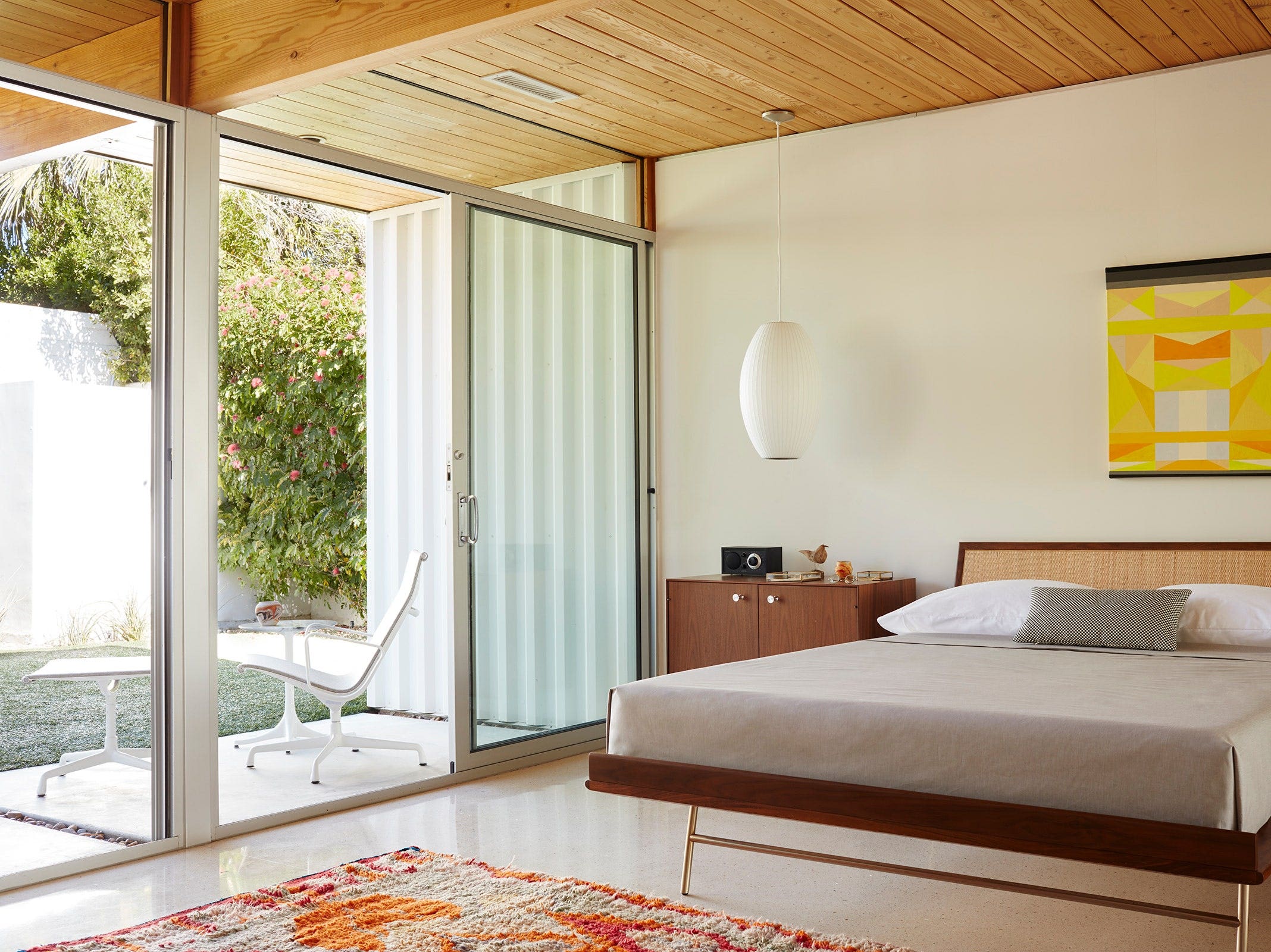 Nelson Thin Edge Bed with cane headboard in a mid-century bedroom with Nelson Bubble Lamp and Thin Edge Chest